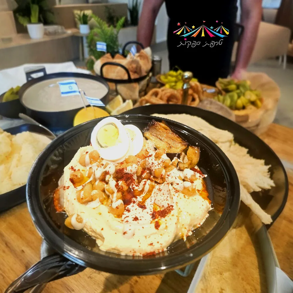 עמדת זירת המנגבים מעוצבת מעץ עם חומוס ופלאפל טרי
